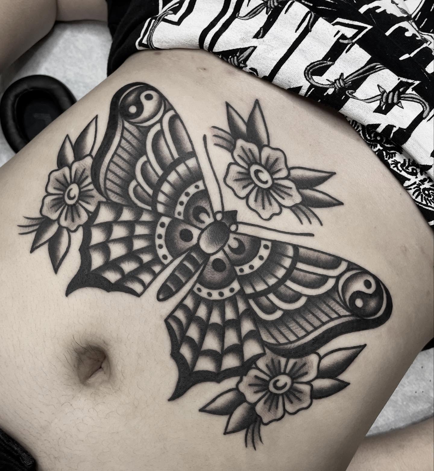 Butterfly and flowers American traditional tattoo on the thigh by Kat, Sacramento, California