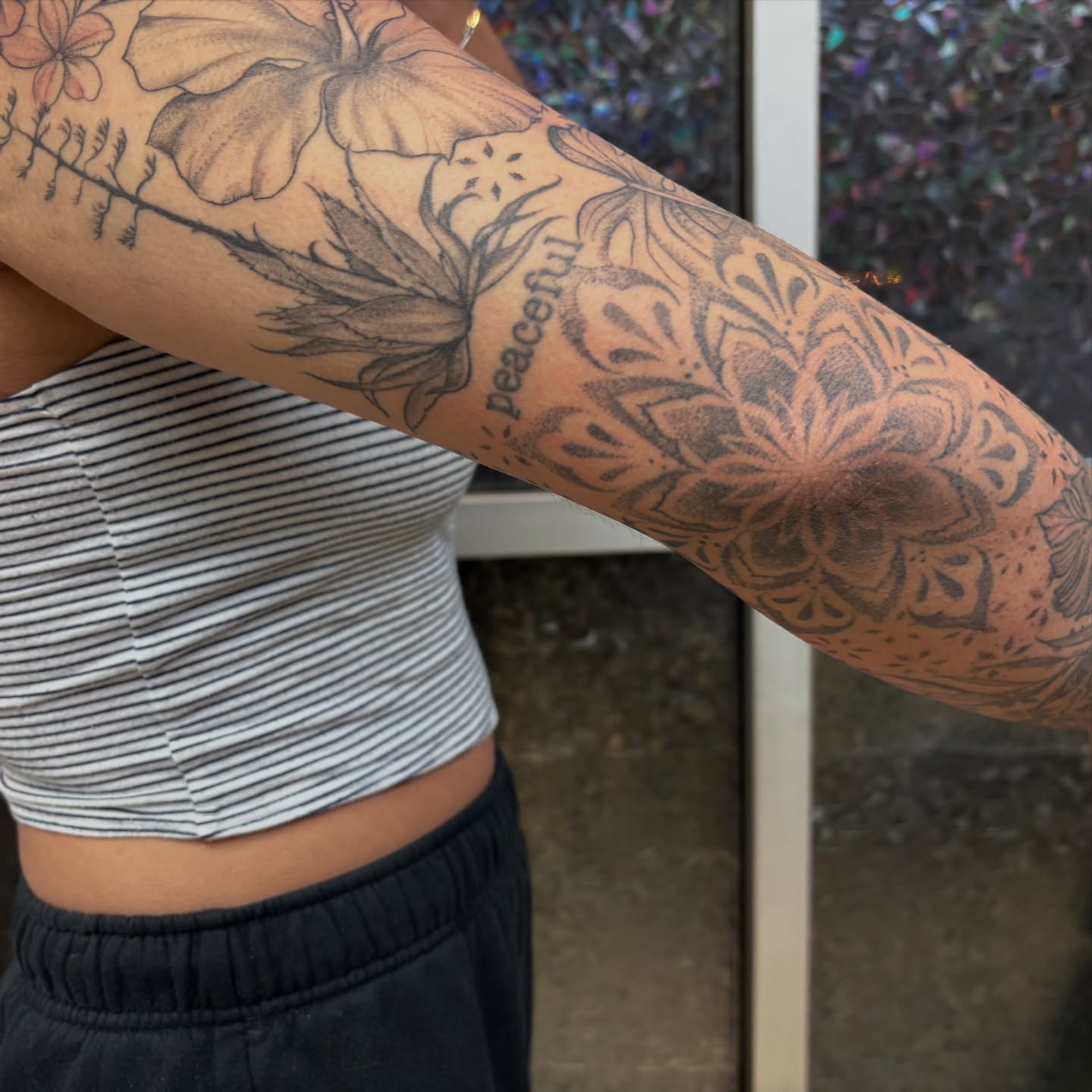 Floral design black and grey tattoo on the forearm by Ivanna