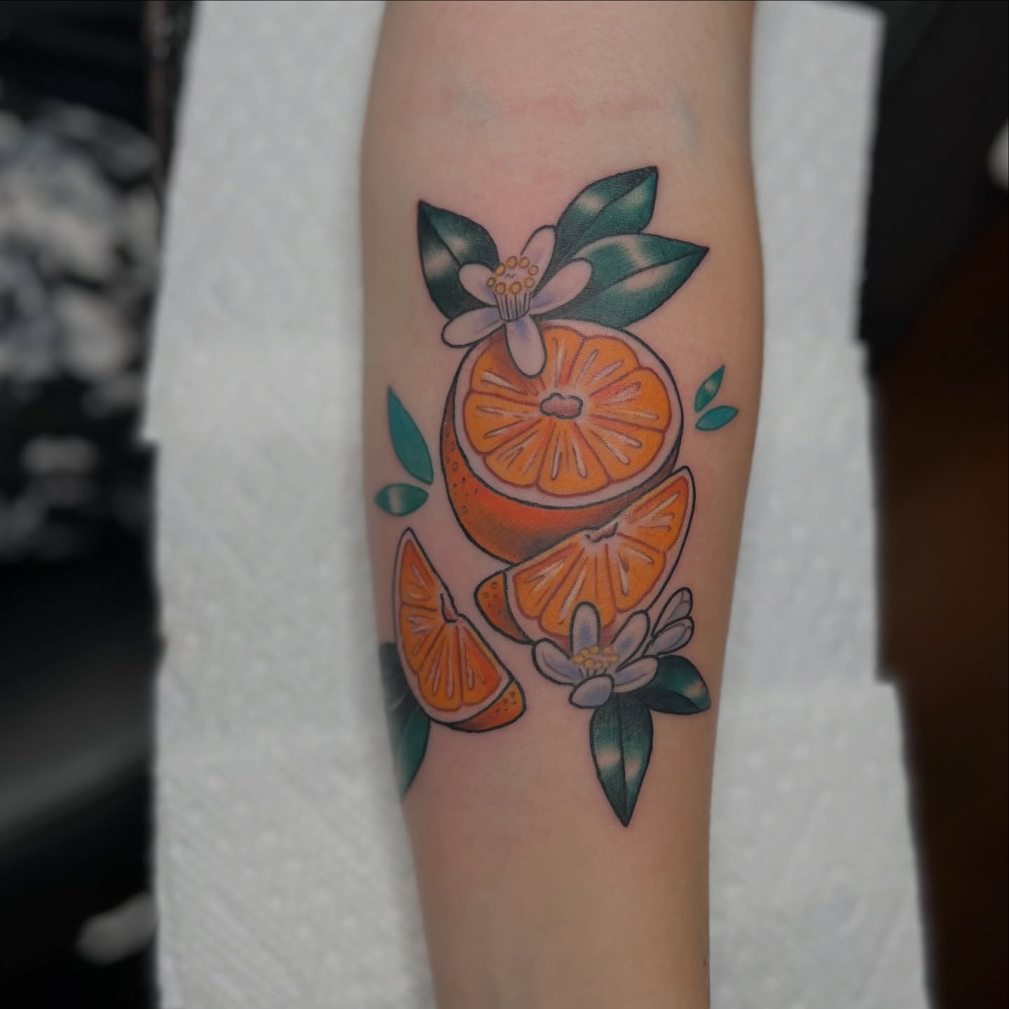 Orange slices and flowers new school tattoo on the forearm by 𝗕𝗿𝗮𝗻𝗱𝘆  𝗪𝗼𝗼𝗱𝗳𝗼𝗿𝗱