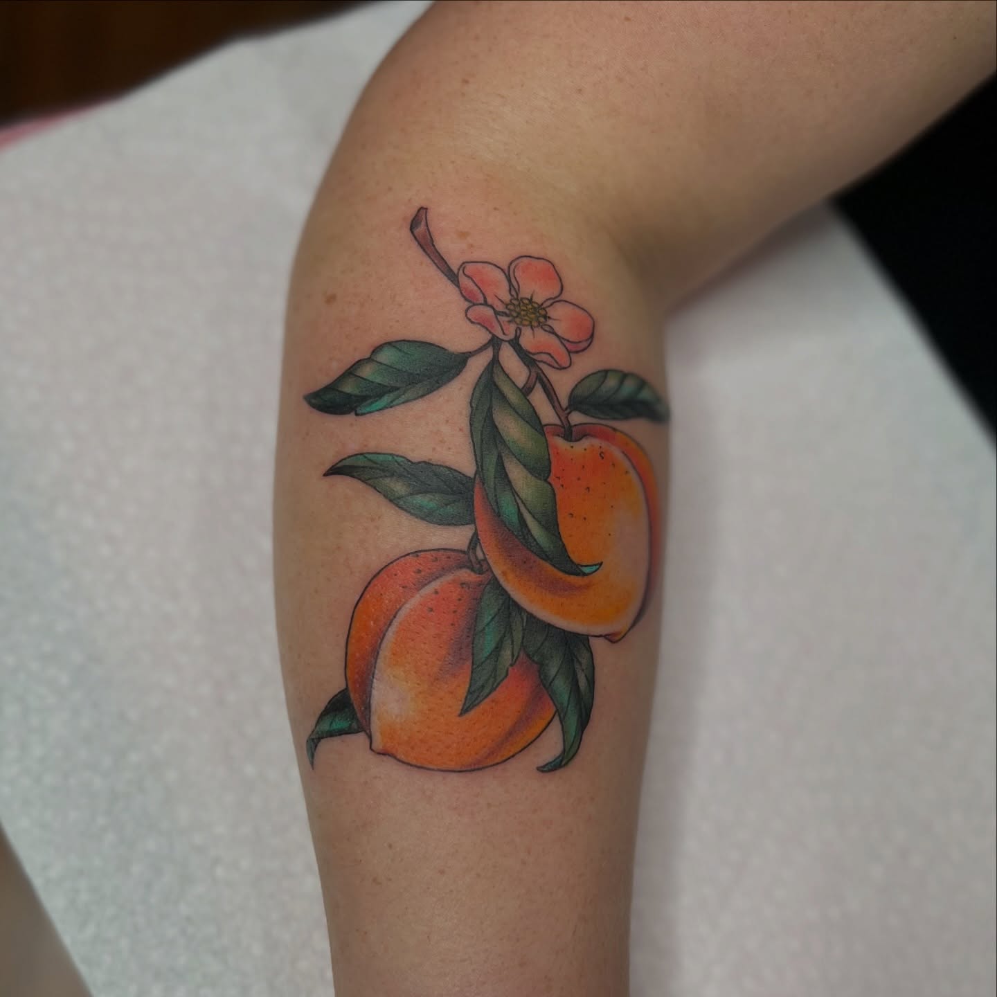 Peaches and flower realism tattoo on the forearm by 𝗕𝗿𝗮𝗻𝗱𝘆  𝗪𝗼𝗼𝗱𝗳𝗼𝗿𝗱