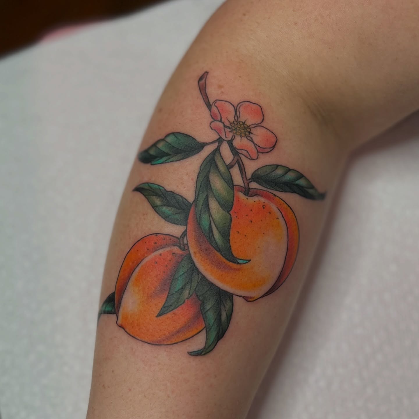 Peaches and flower American traditional tattoo on the forearm by 𝗕𝗿𝗮𝗻𝗱𝘆  𝗪𝗼𝗼𝗱𝗳𝗼𝗿𝗱