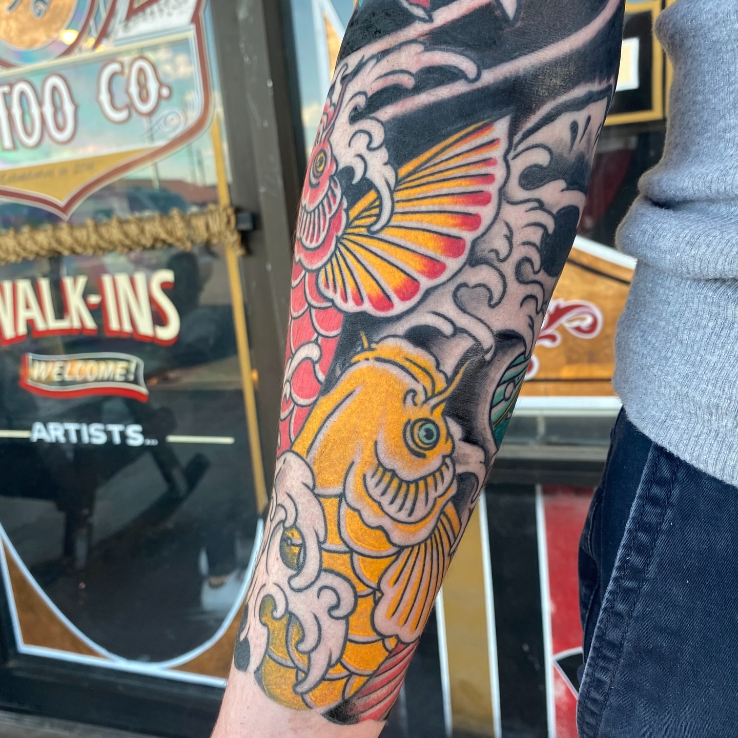 Koi fish American traditional tattoo on the forearm by Nick Weaver