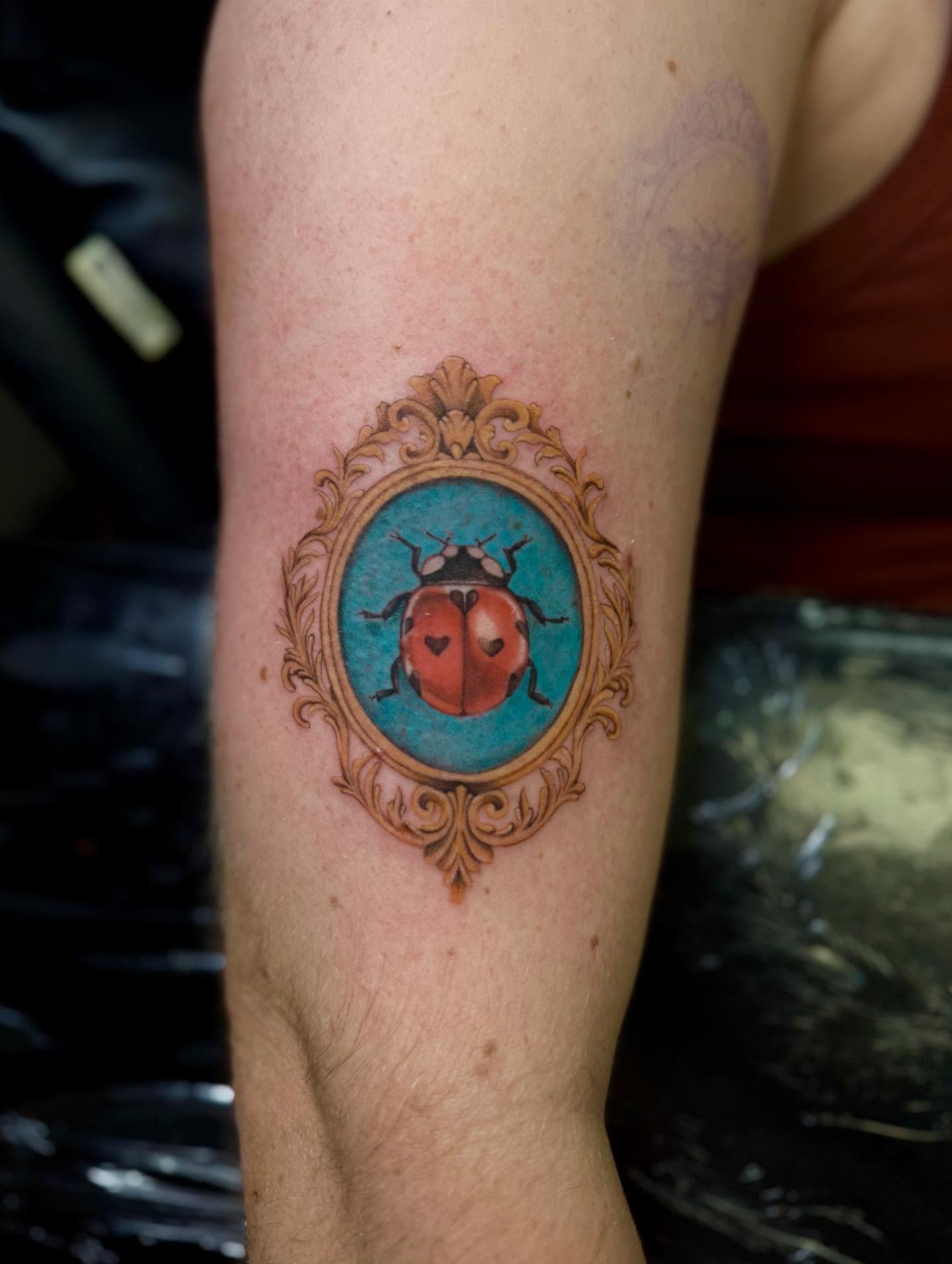 Ladybug realism tattoo on the forearm by Anna