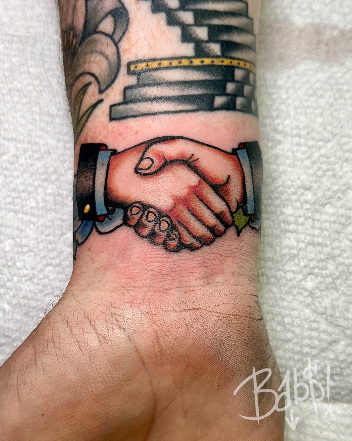 Robot handshake neo-traditional tattoo on the forearm by Justin B