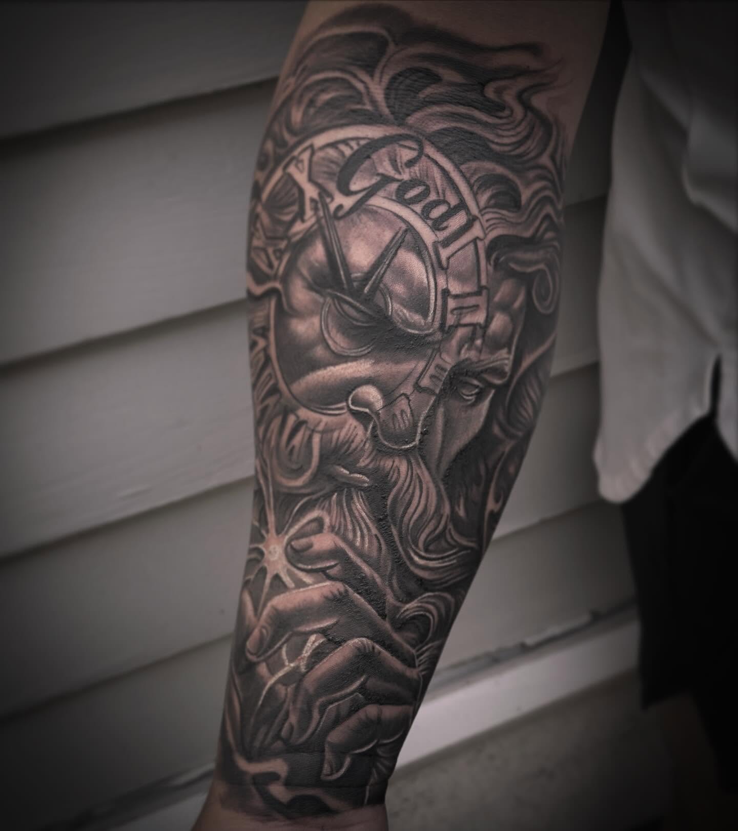 God-like figure realism tattoo on the forearm by Eric Zuluaga