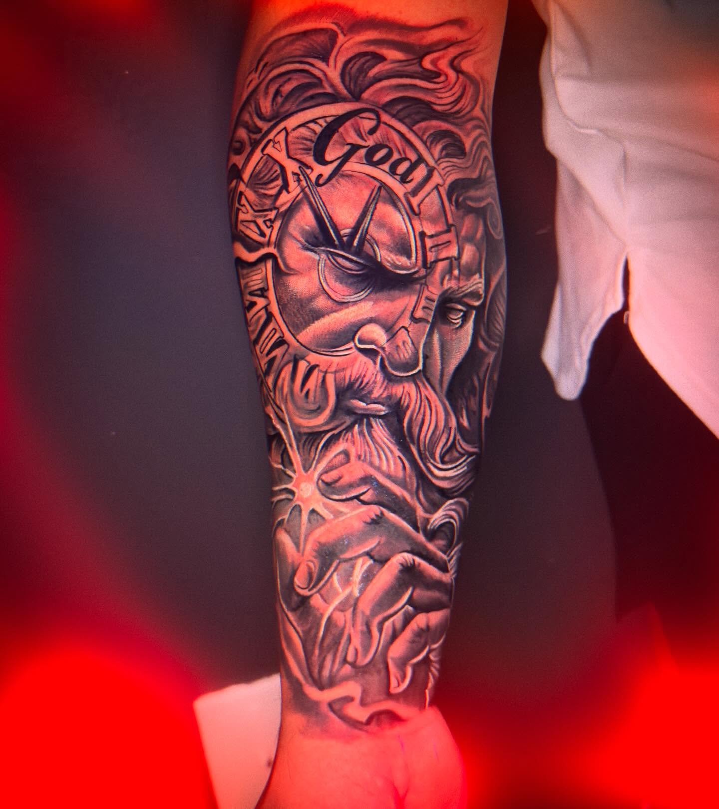 Godly figure realism tattoo on the forearm by Eric Zuluaga