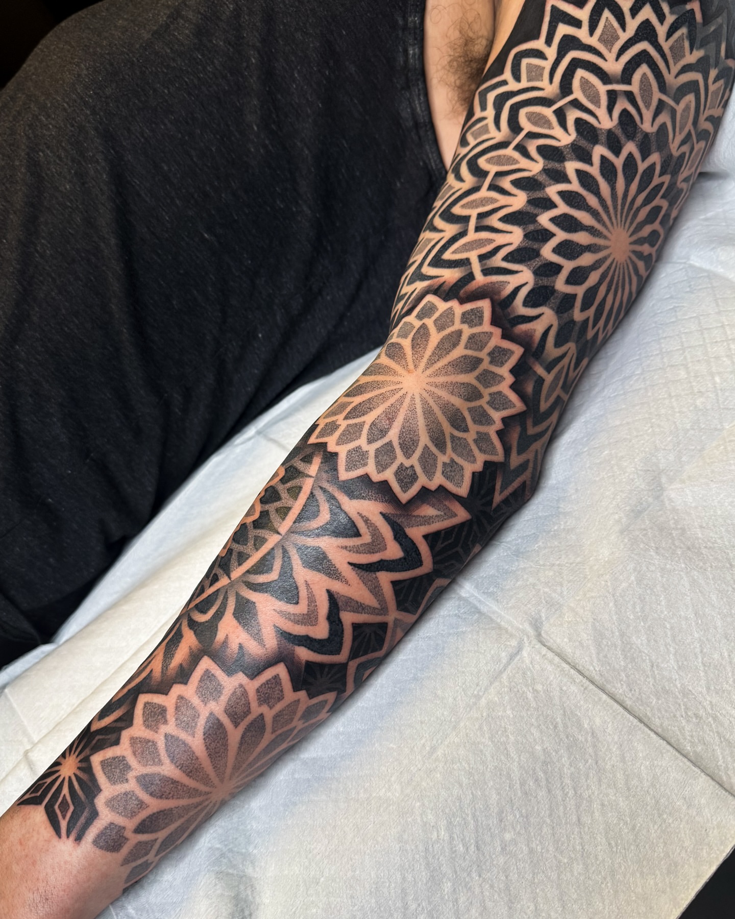 Lotus flower black and grey tattoo on the forearm by Ross Krandel
