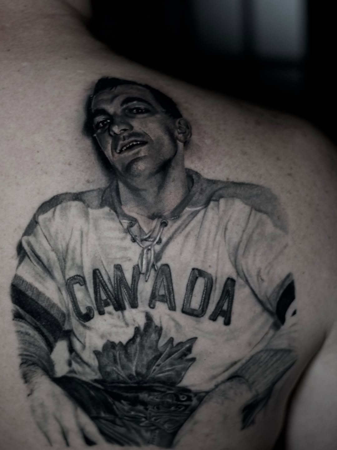 Portrait of a hockey player tattoo on the shoulder by Justin Shelpman