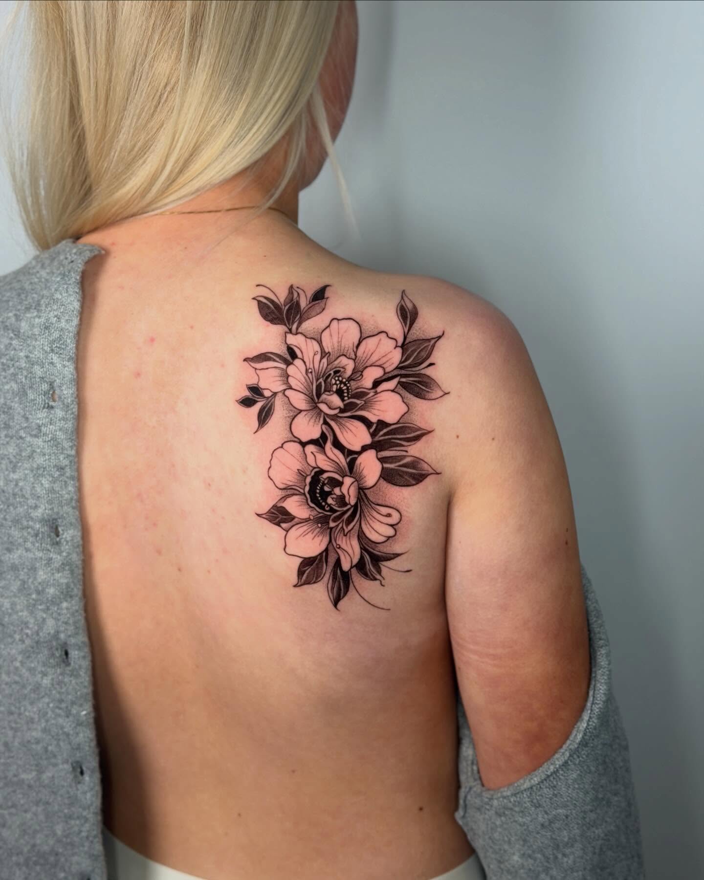 Floral bouquet black and grey tattoo on the shoulder by Felipe Pacifico