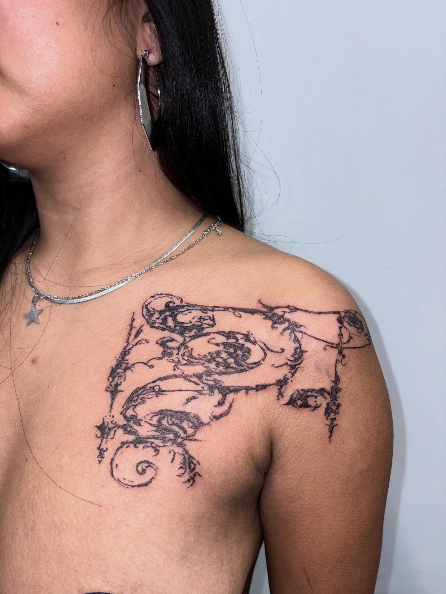 Astronomical instrument black and grey tattoo on the shoulder by madeline