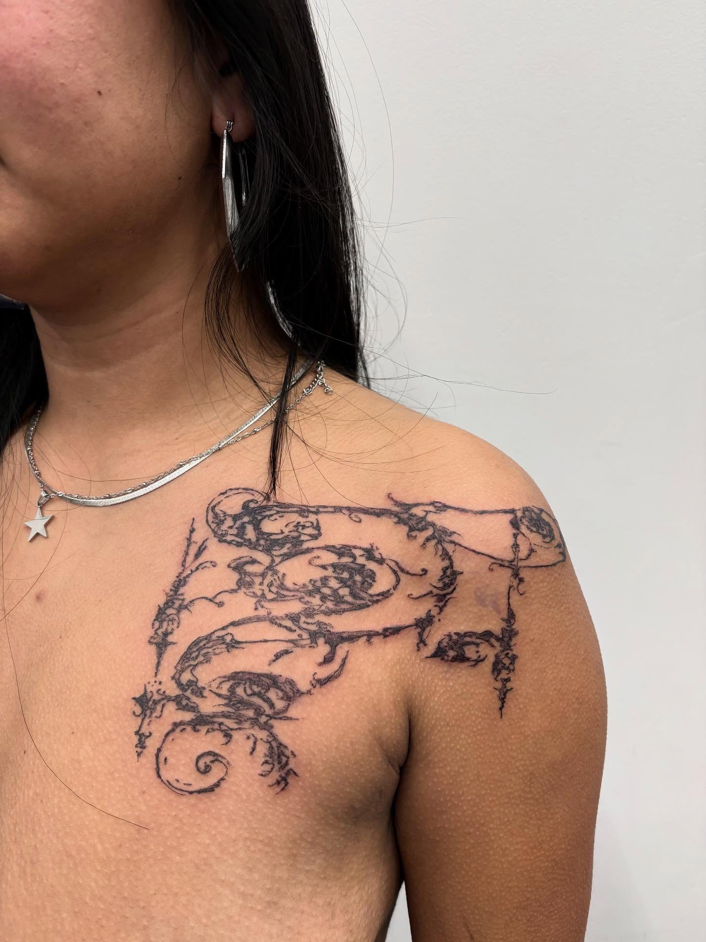 Serpent black and grey tattoo on the shoulder by madeline