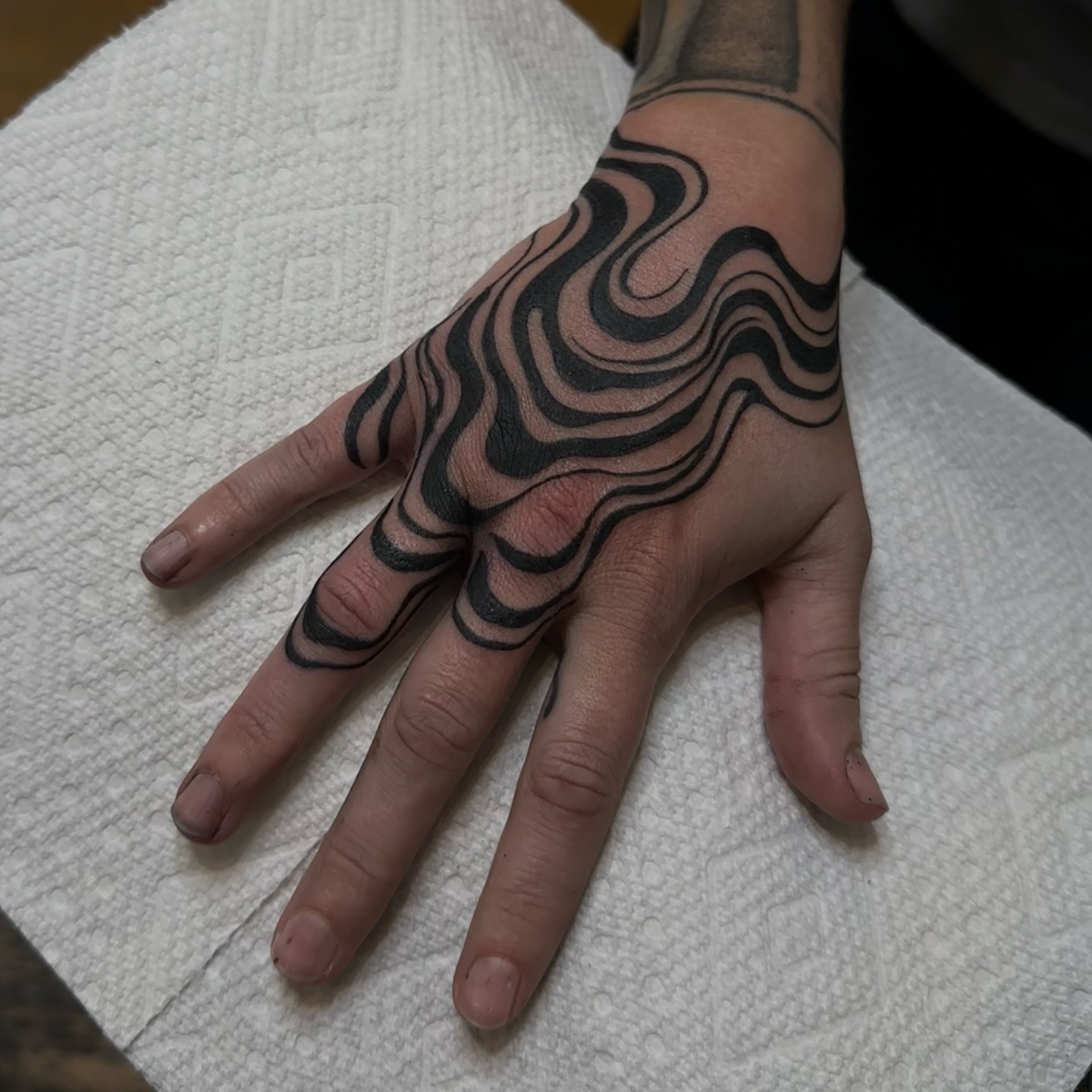 Wave pattern black and grey tattoo on the hand by Адріянна Стабс 🇺🇦, New York, New York