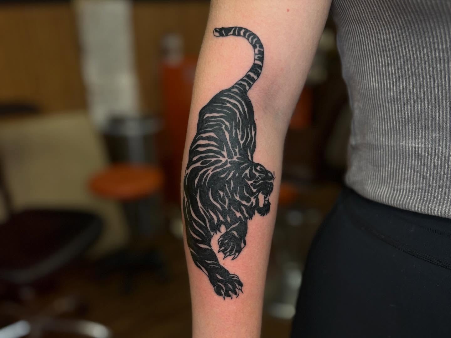 Tiger black and grey tattoo on the forearm by Lauren Deets