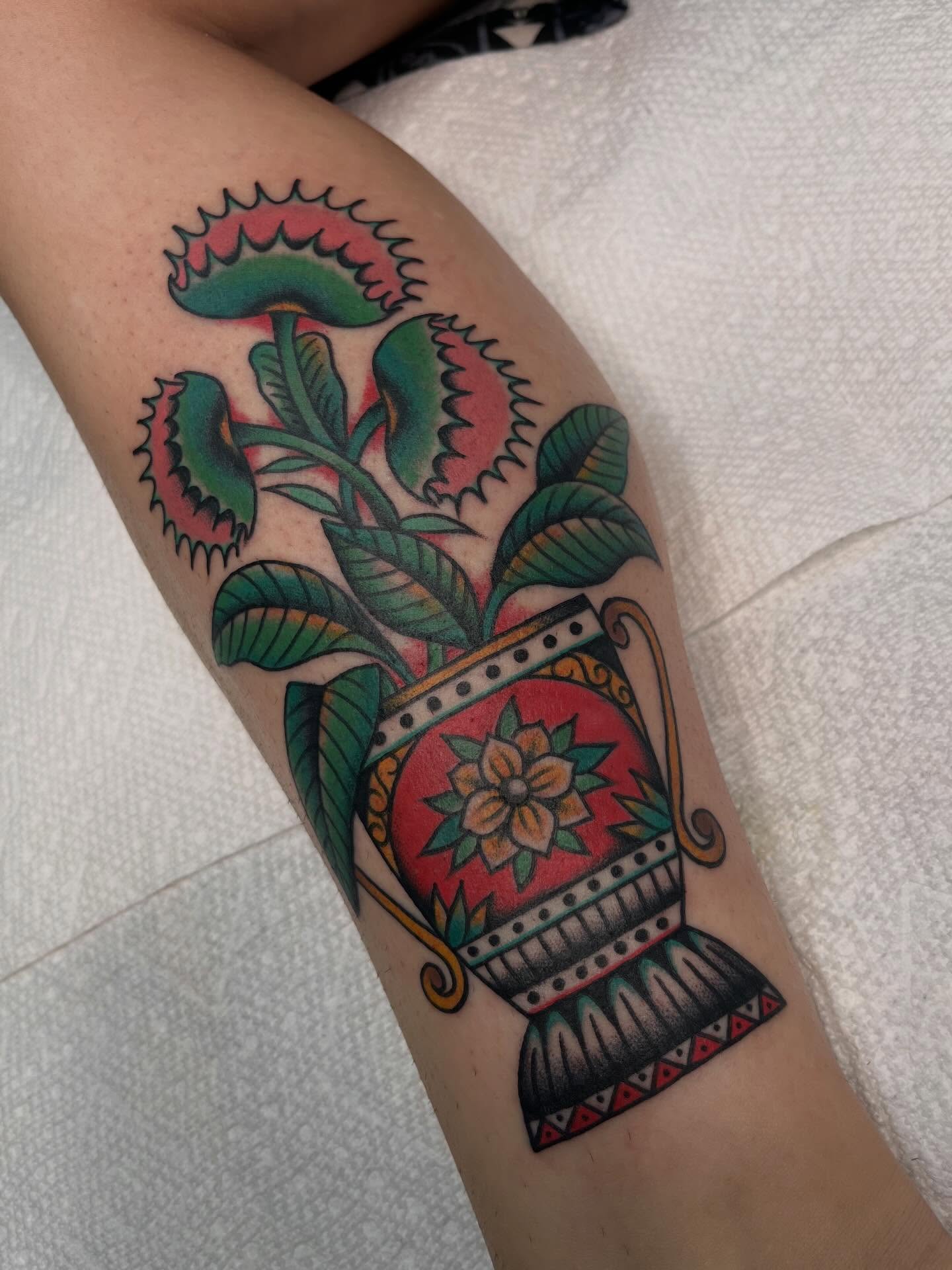 Vase with carnivorous plants American traditional tattoo on the forearm by ๐๐ฎ๐ฌ๐ญ๐ข๐ง ๐๐จ๐ฐ๐๐ซ๐, Oakland, California