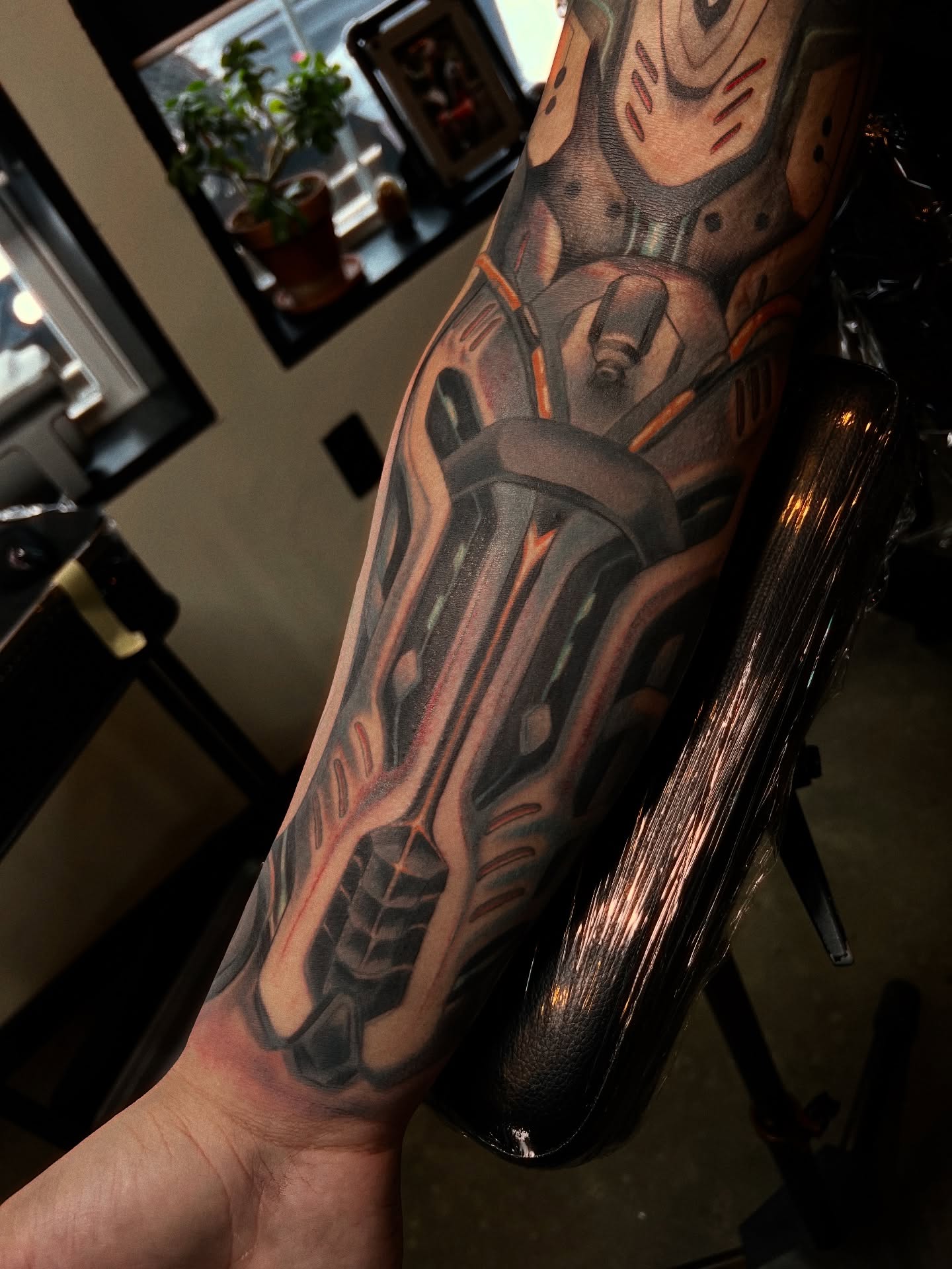 Cyborg arm geometric tattoo on the forearm by Amanda Leitch