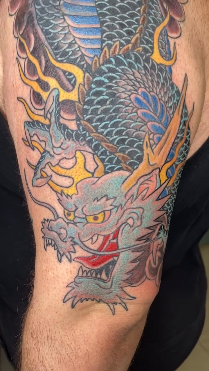 Dragon sleeve Japanese tattoo on the upper arm by Dice Lyon
