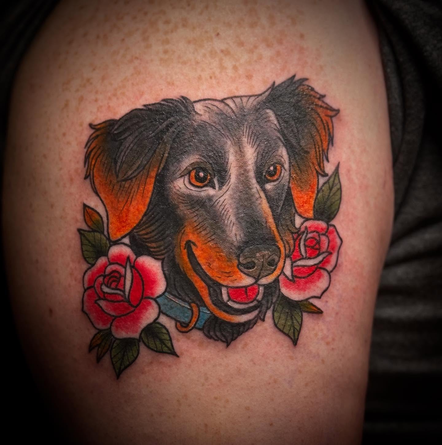 Dog with roses American traditional tattoo on the shoulder by ArJay Smith