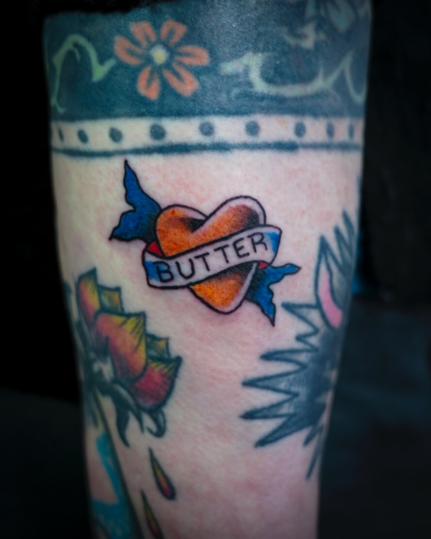 Heart with banner American traditional tattoo on the forearm by Spicoli