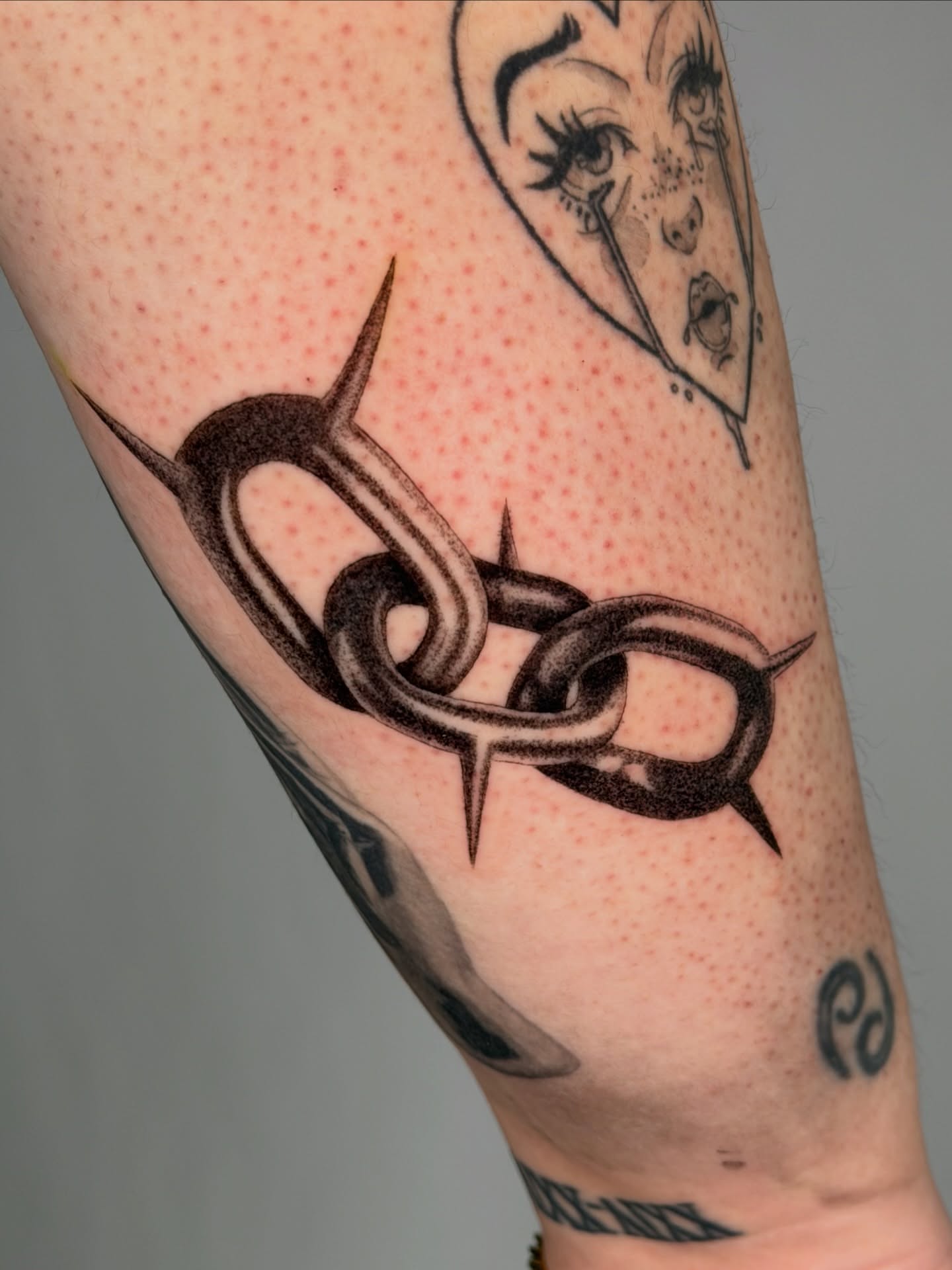 Chain black and grey tattoo on the forearm by Jerm Lewis