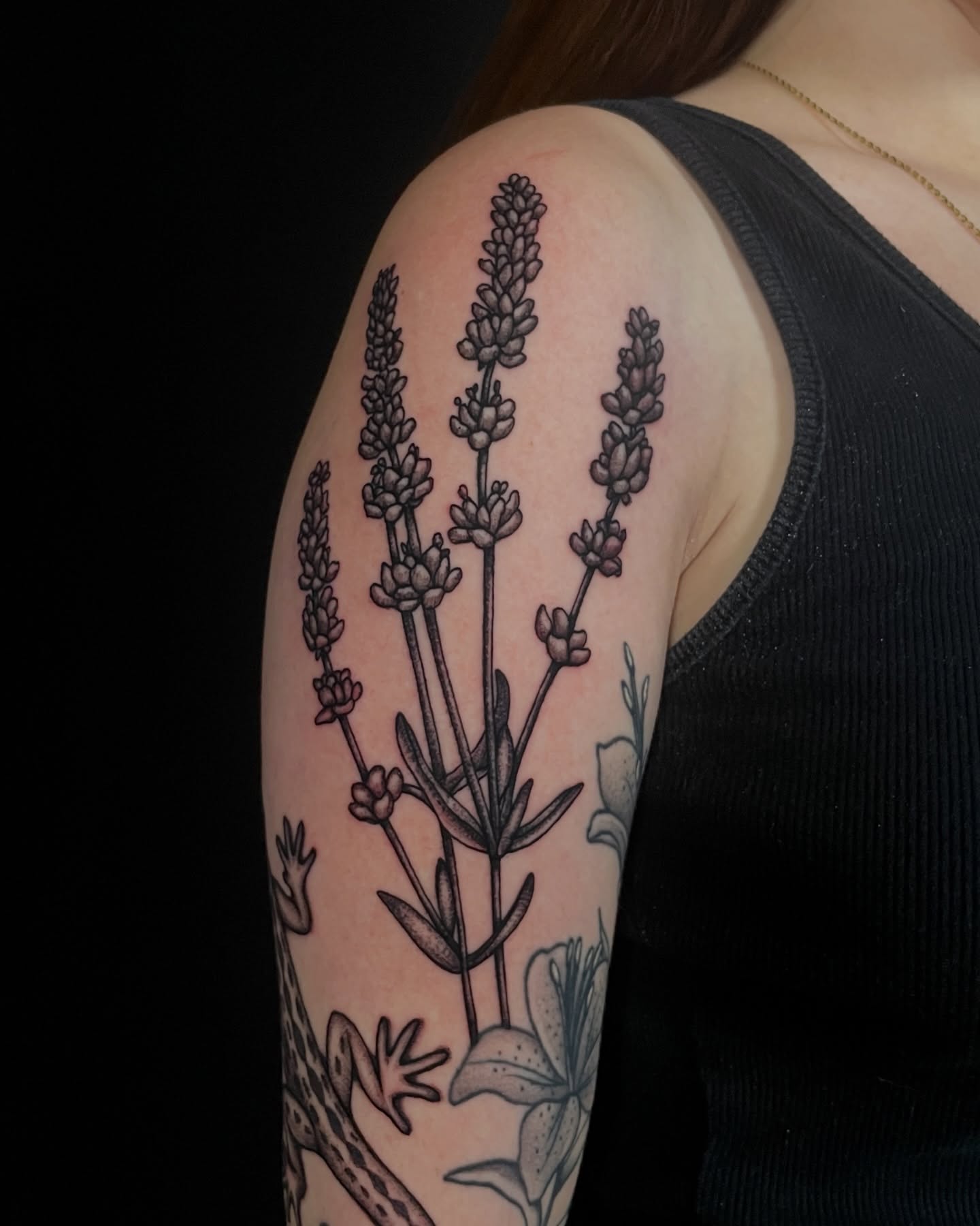 Lavender plant black and grey tattoo on the upper arm by Austin Clark