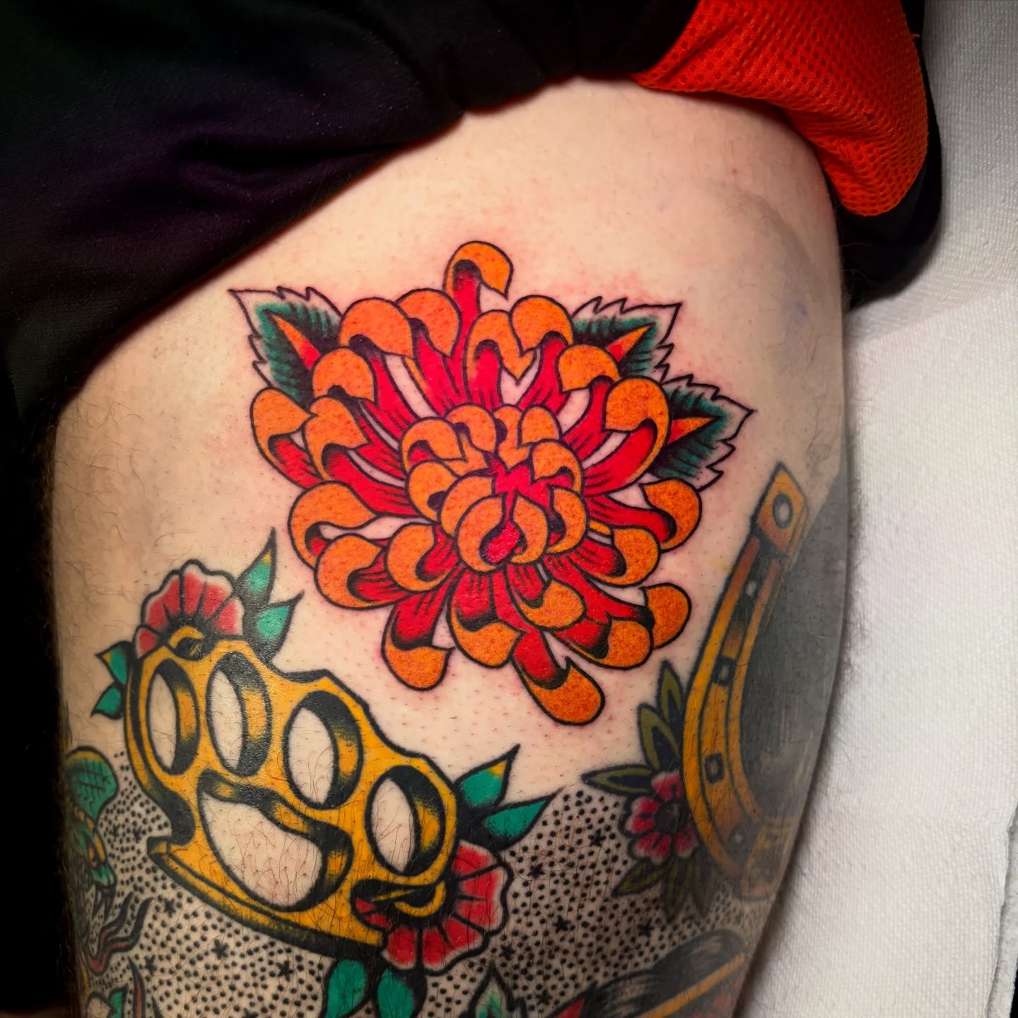 Chrysanthemum American traditional tattoo on the thigh by Matt Elliott, Murfreesboro, Tennessee