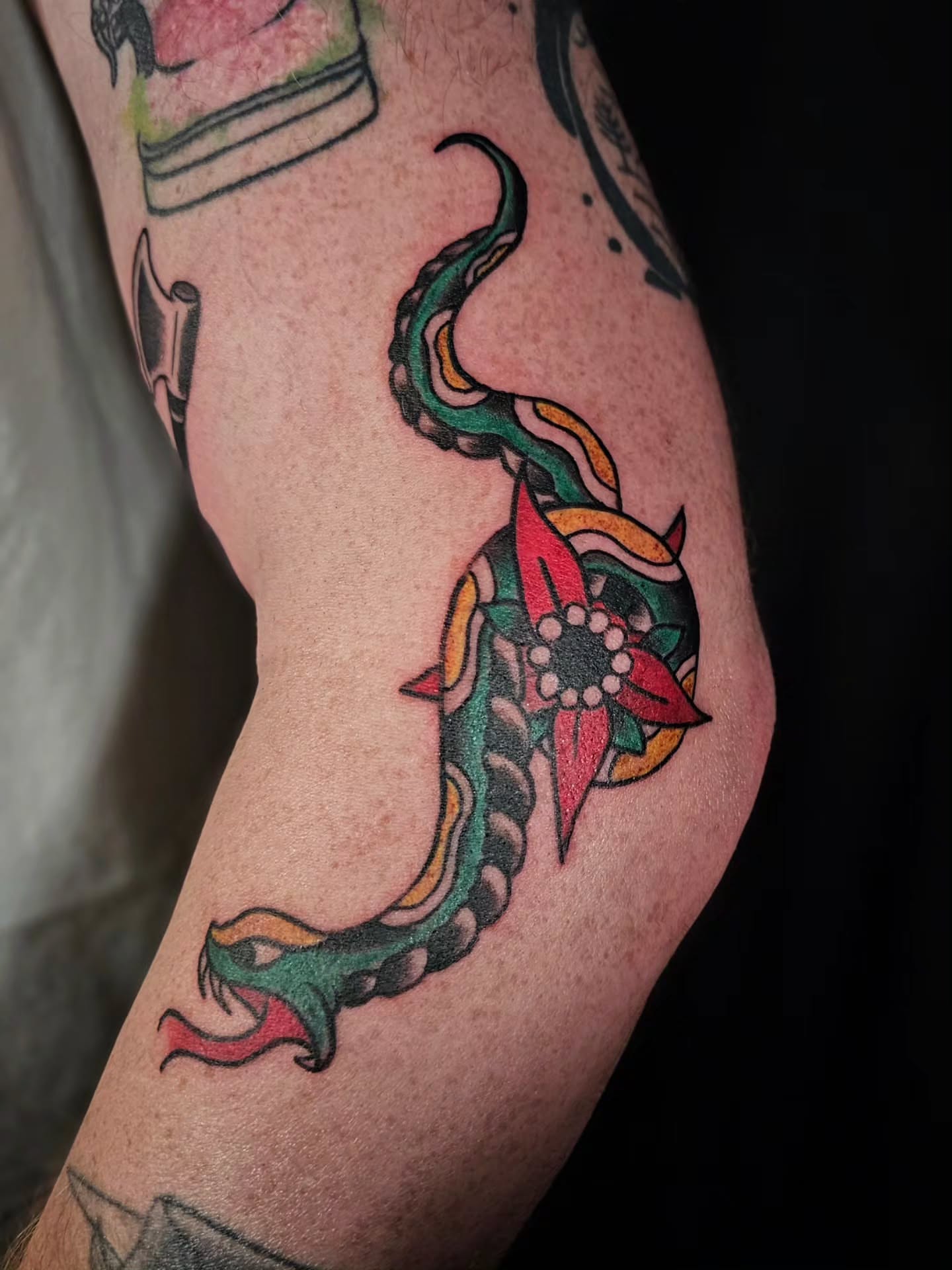 Snake and flower new school tattoo on the forearm by J. Arturo Laparra