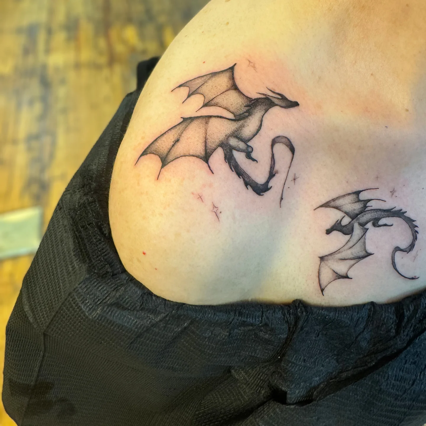 Dragons black and grey tattoo on the shoulder by Niki Jackson