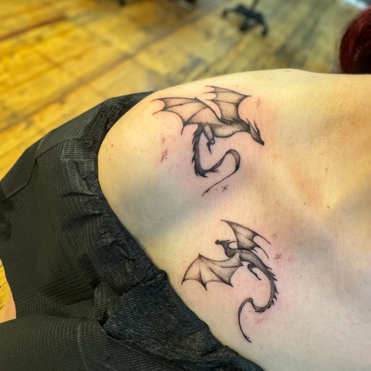 Dragons black and grey tattoo on the shoulder by Niki Jackson