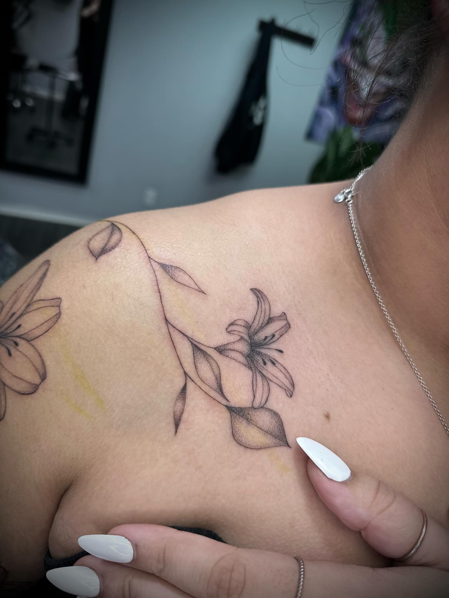 Lily black and grey tattoo on the shoulder by Bell