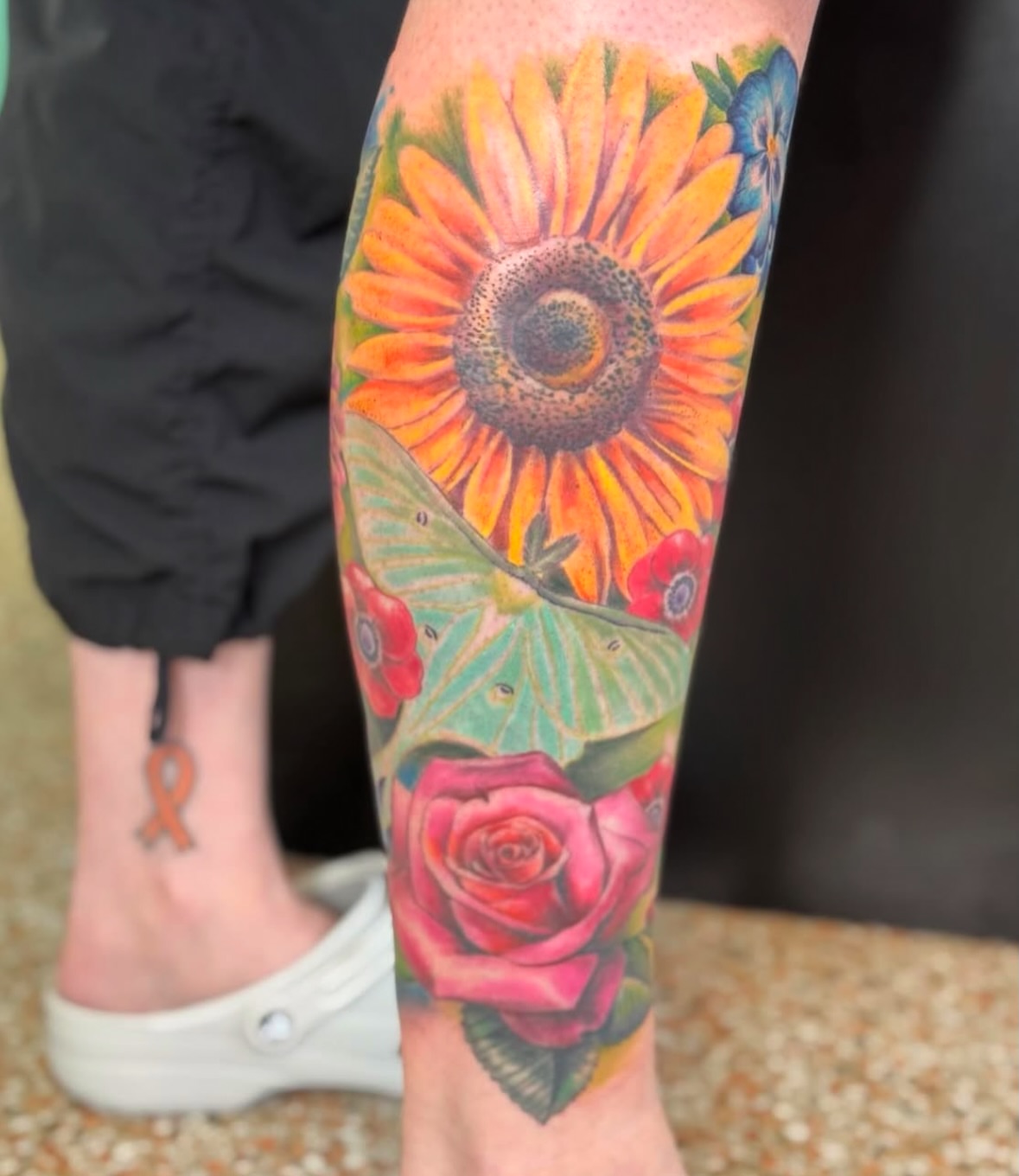 Sunflower and butterfly realism tattoo on the calf by Vega
