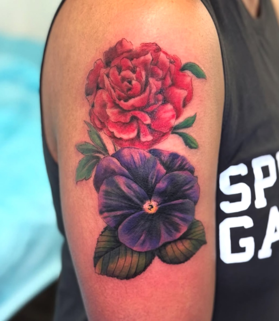 Flower tattoo realism tattoo on the upper arm by Vega