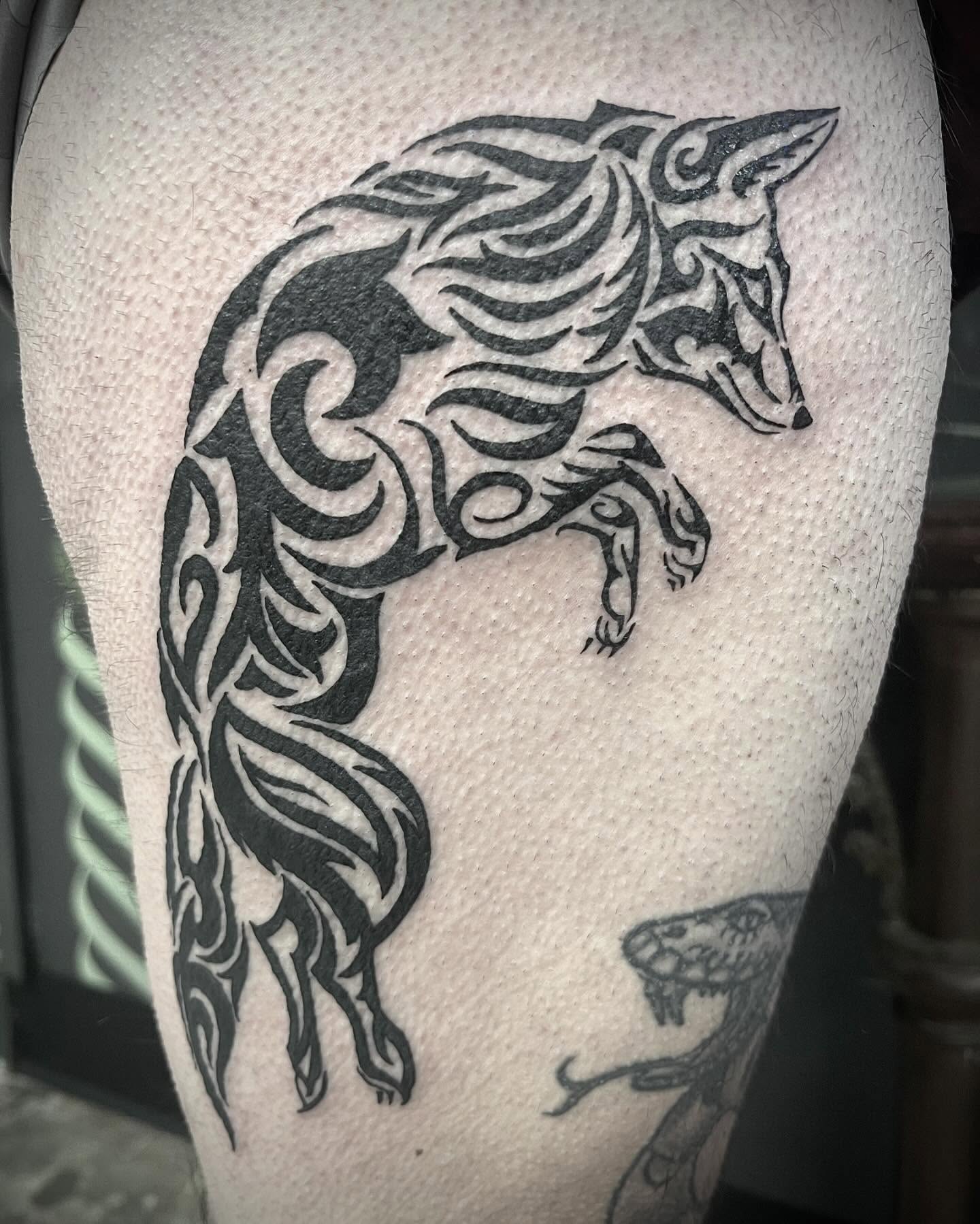 Wolf tribal tattoo on the thigh by Natalie Phillips, Oakland, California