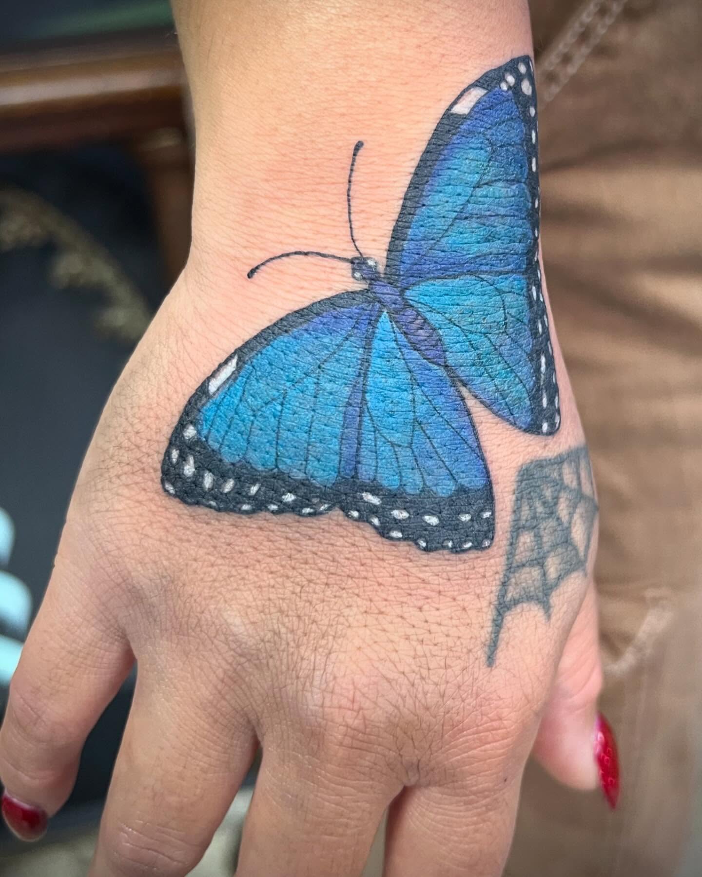 Blue butterfly realism tattoo on the hand by Natalie Phillips, Oakland, California