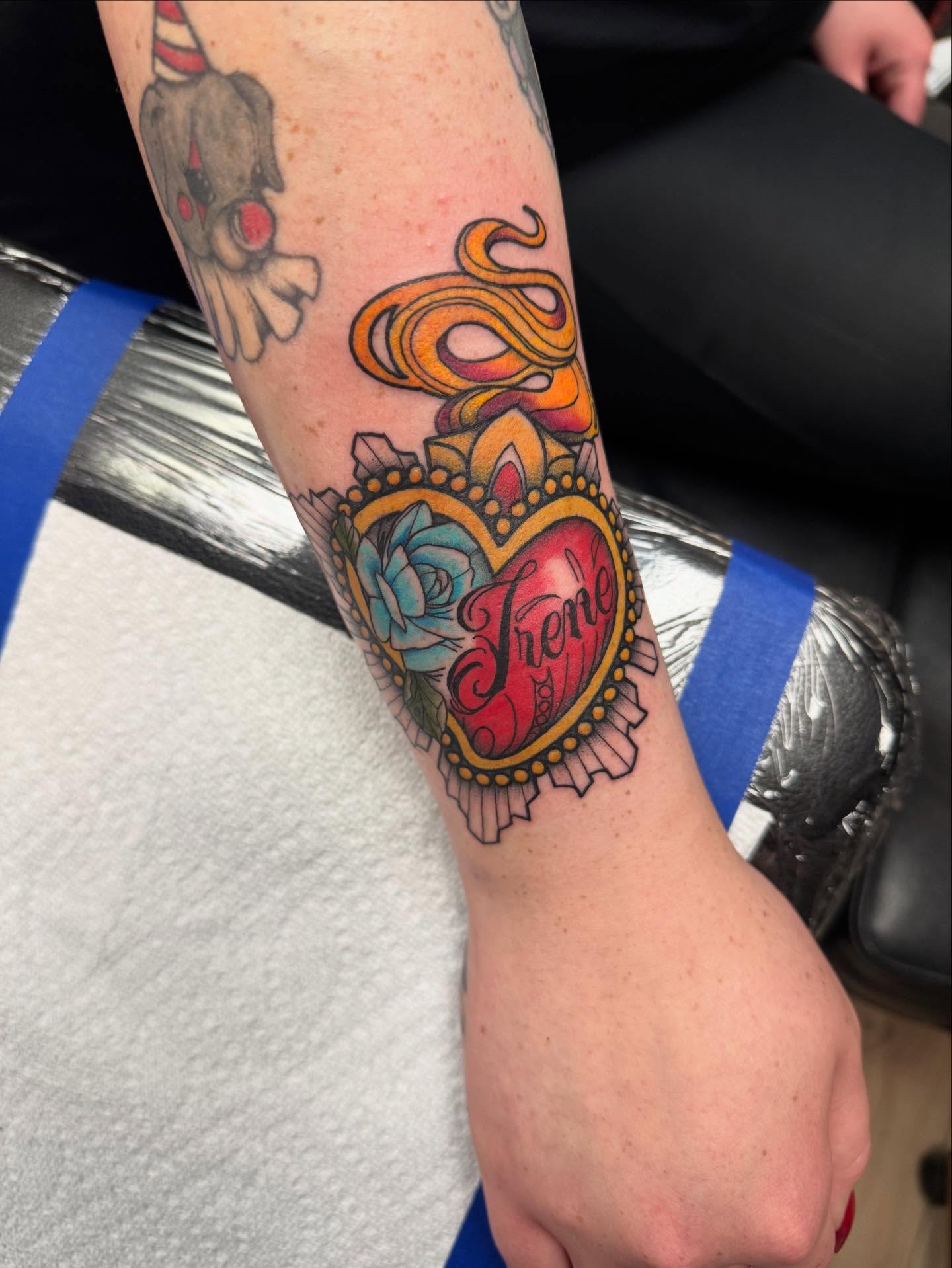 Heart with snake American traditional tattoo on the forearm by Jon Fleming