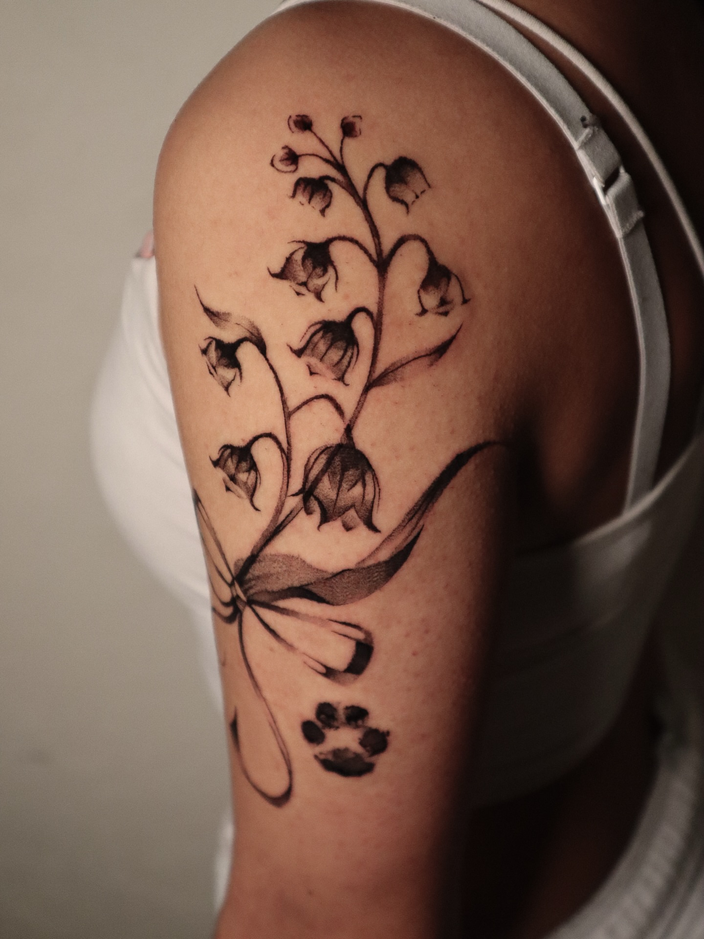 Lily of the valley black and grey tattoo on the shoulder by 𝕮𝖔𝖓𝖓𝖔𝖗 ☾  ~ TATTOO ARTIST