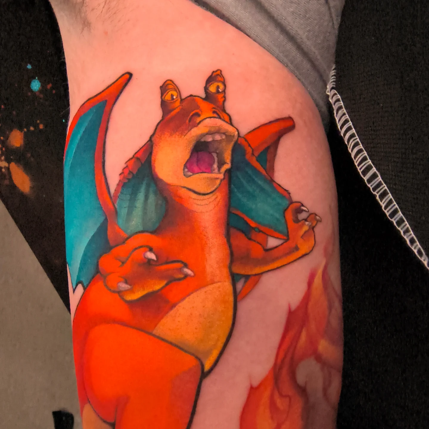 Charizard realism tattoo on the thigh by Jorell Elie
