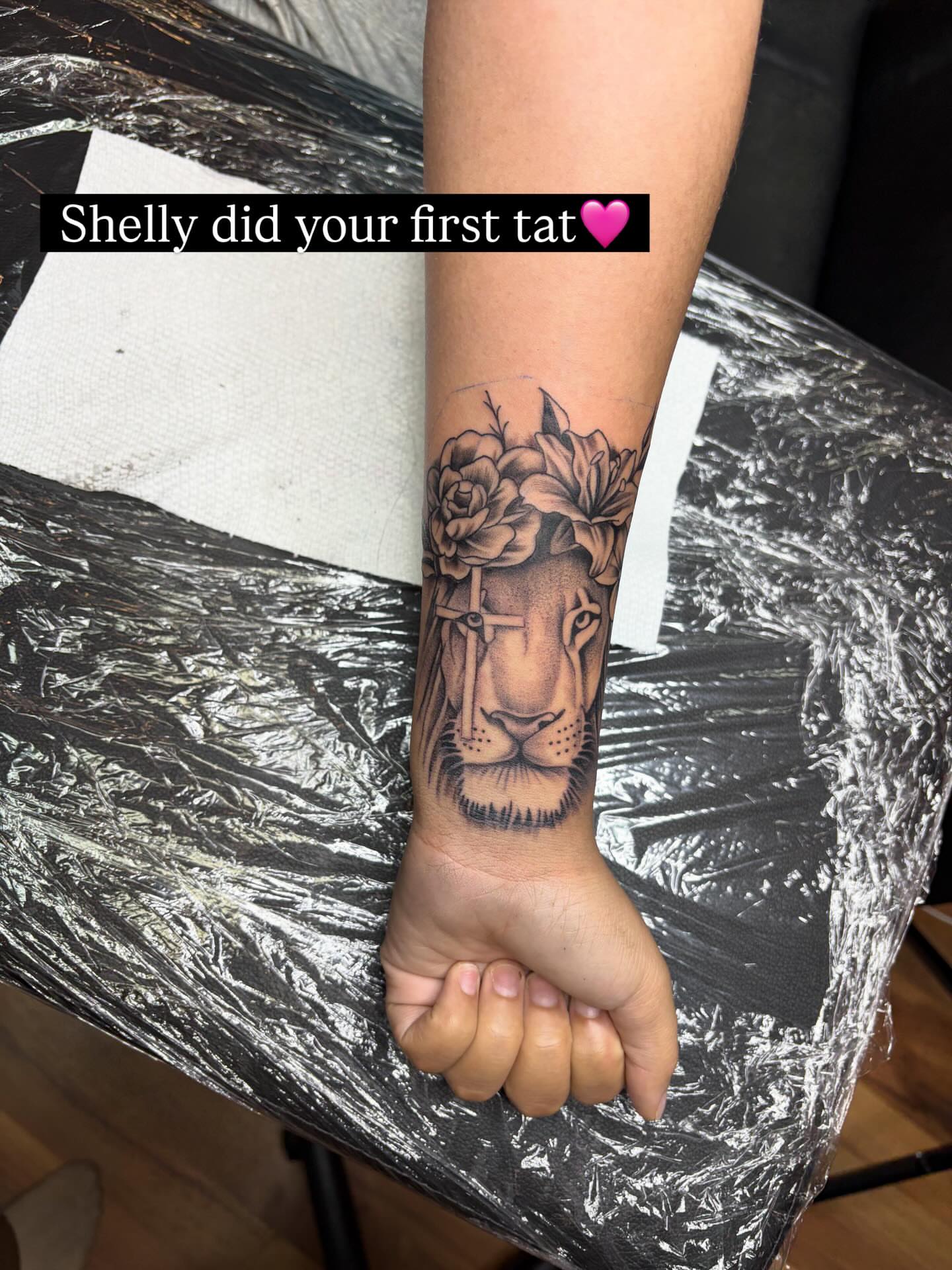 Lion with floral crown realism tattoo on the forearm by 𓂀 𝕊ℍ𝔼𝕃𝕃𝕐 𓂀