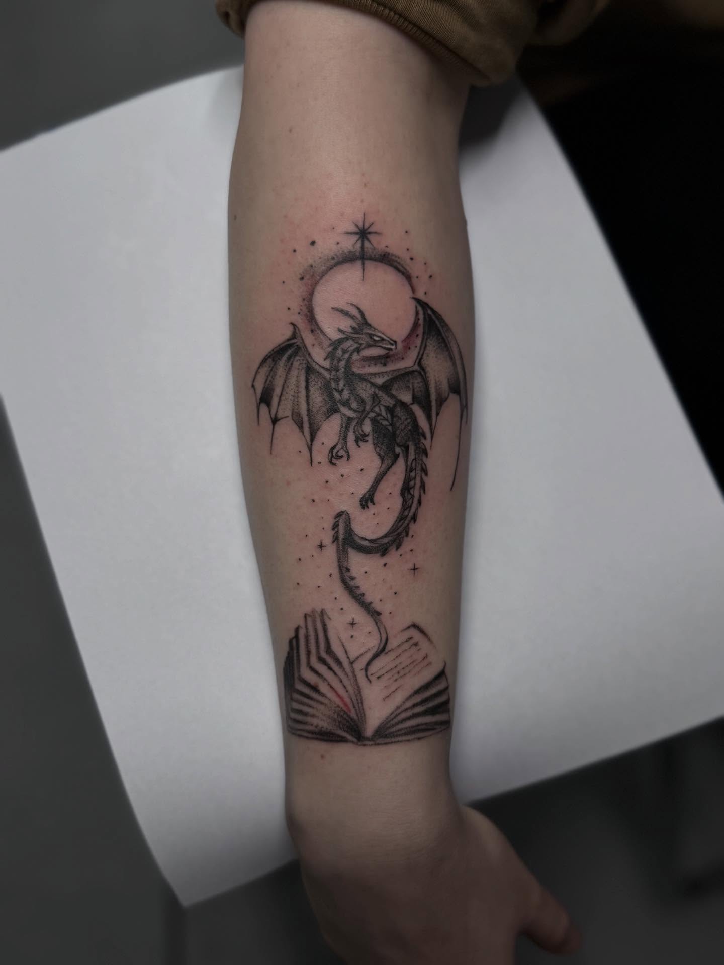 Dragon and book dotwork tattoo on the forearm by Jacob - Tattoo Artist