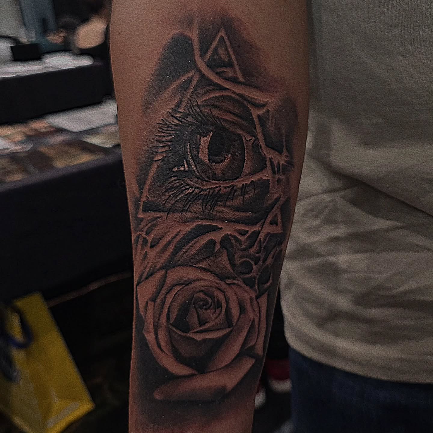 Eye and rose realism tattoo on the forearm by Lissy Red
