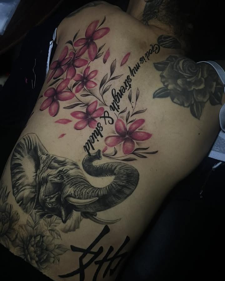 Elephant and flowers realism tattoo on the back by Ferlandis Fitch, Long Beach, California