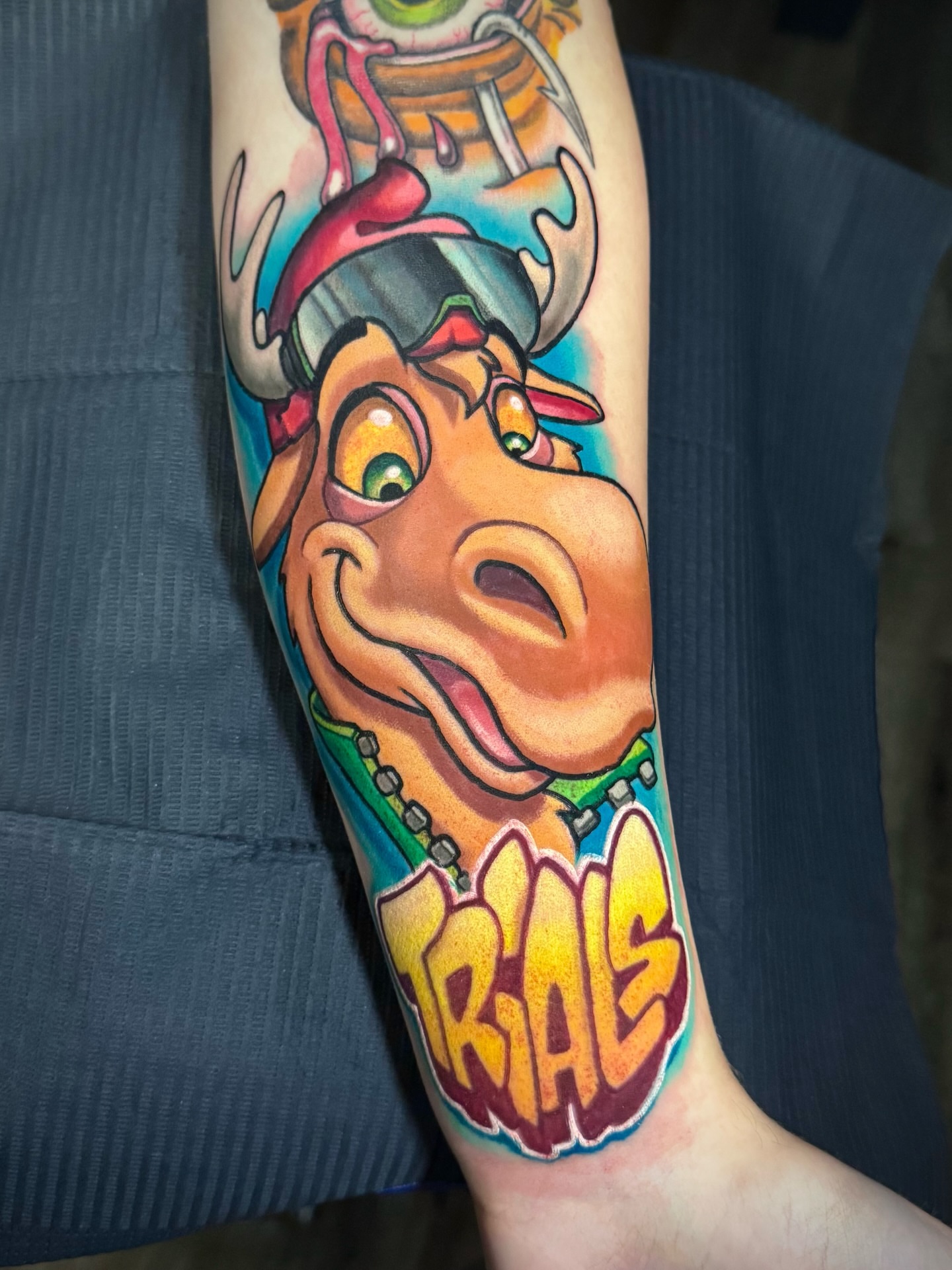 Cow character new school tattoo on the forearm by Kevin Boudreau Newschool Tattoos