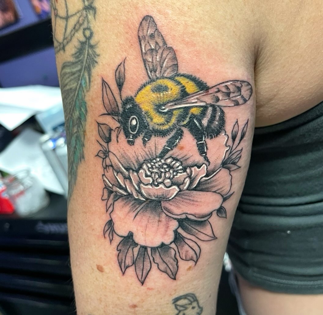 Bee and flower realism tattoo on the forearm by Mark Calloway