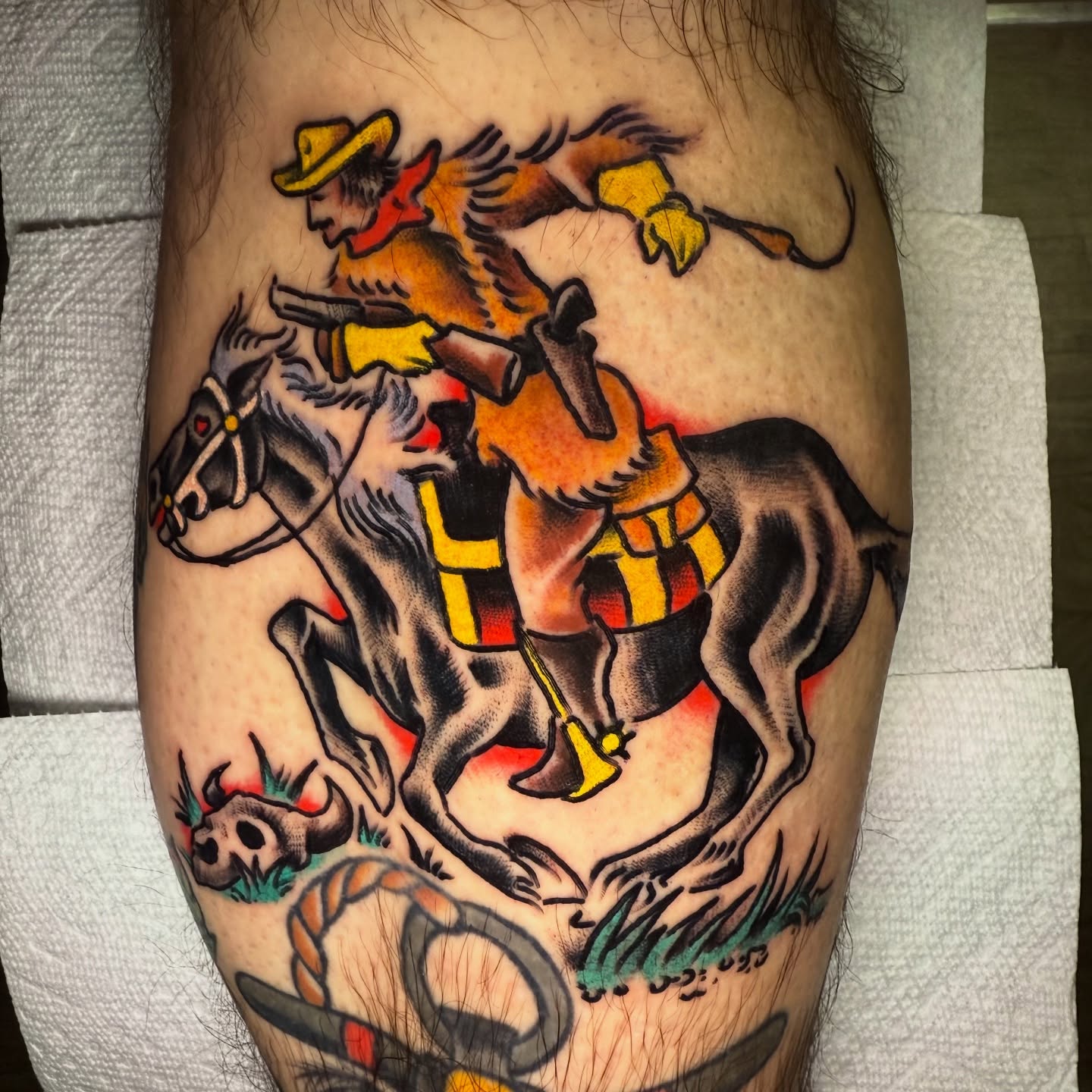 Cowboy riding horse American traditional tattoo on the thigh by Mike Dunn