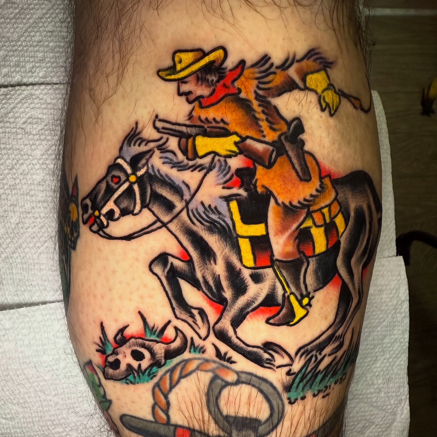 Cowboy riding horse American traditional tattoo on the forearm by Mike Dunn