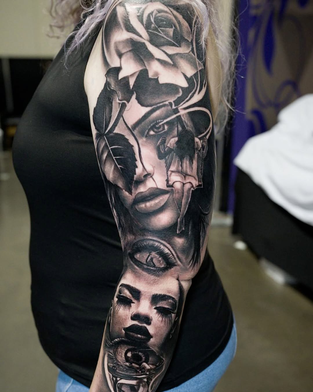 Surreal portrait with rose and eyes realism tattoo on the upper arm by Erick Satchell II