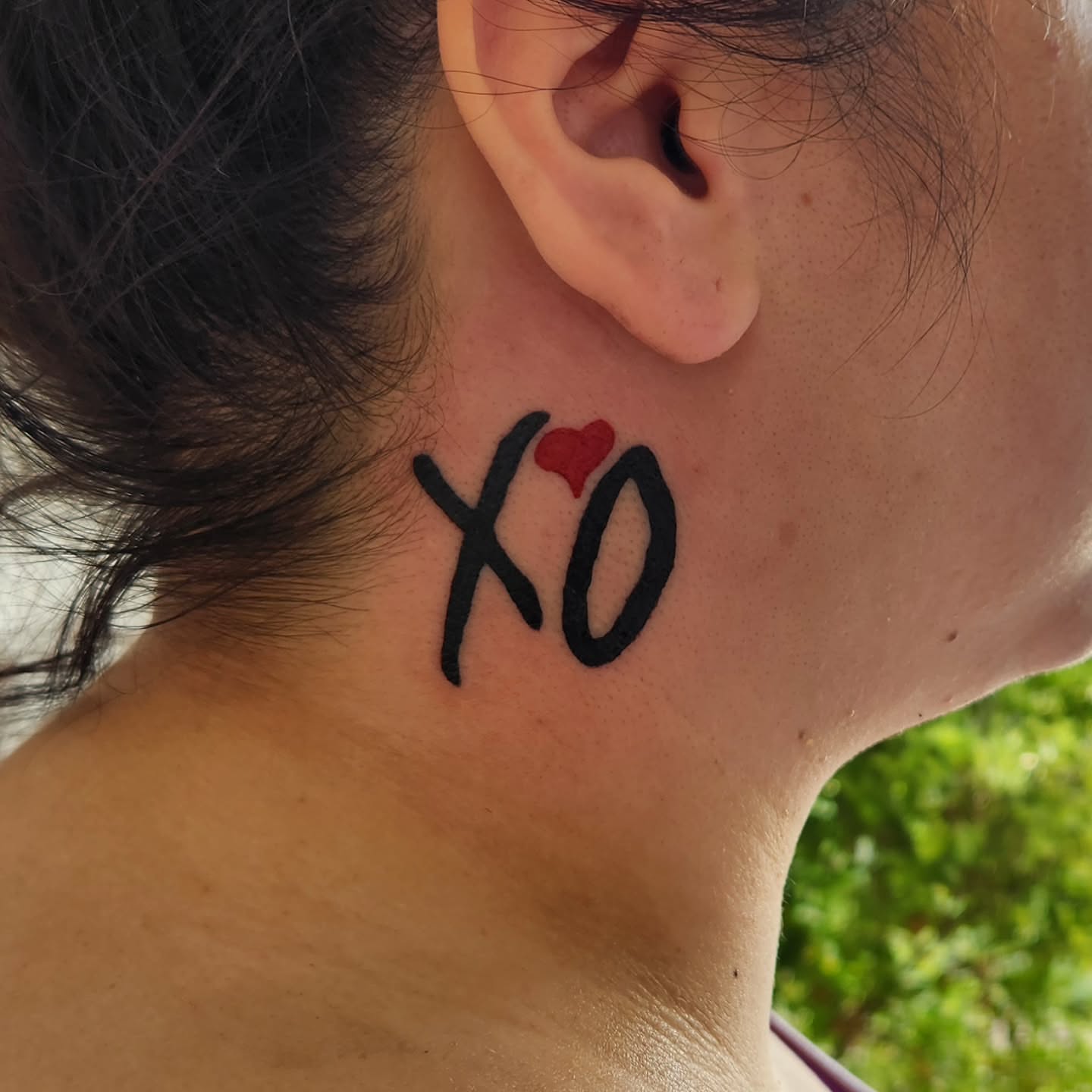 XO with heart lettering script tattoo on the neck by @youxg_guxxz