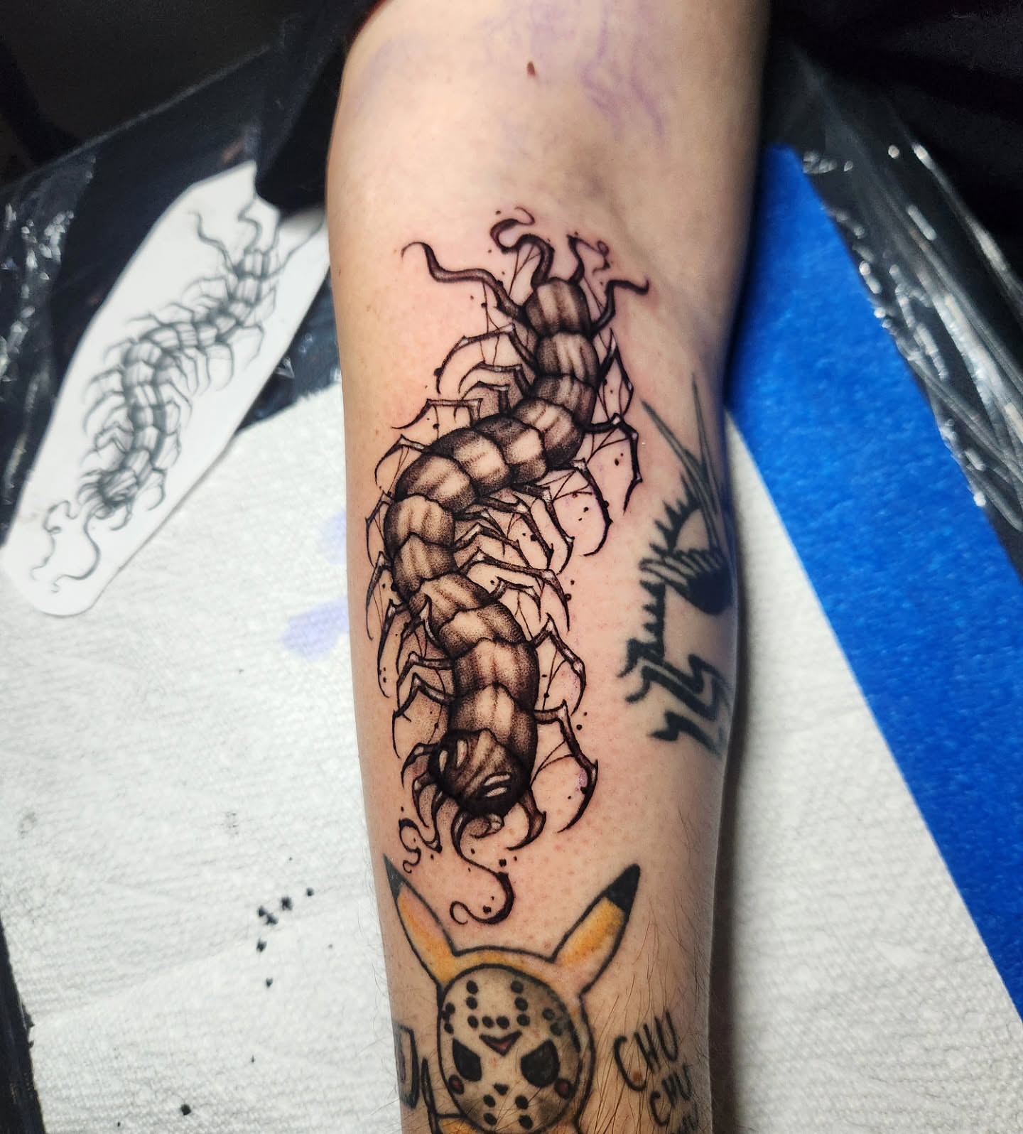 Centipede black and grey tattoo on the forearm by Abby Renteria