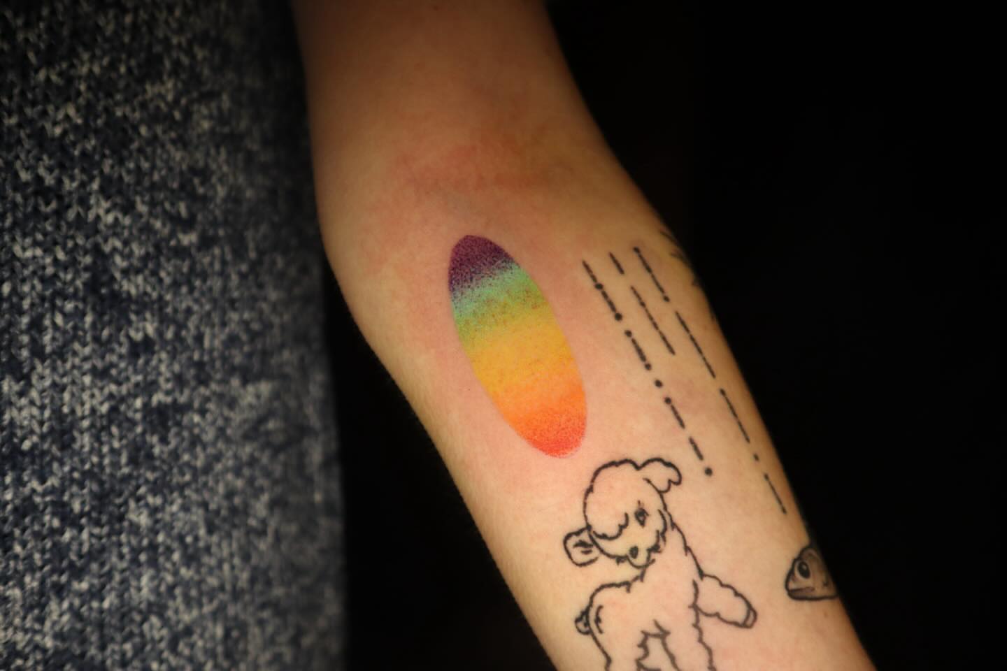 Rainbow dotwork tattoo on the forearm by dani
