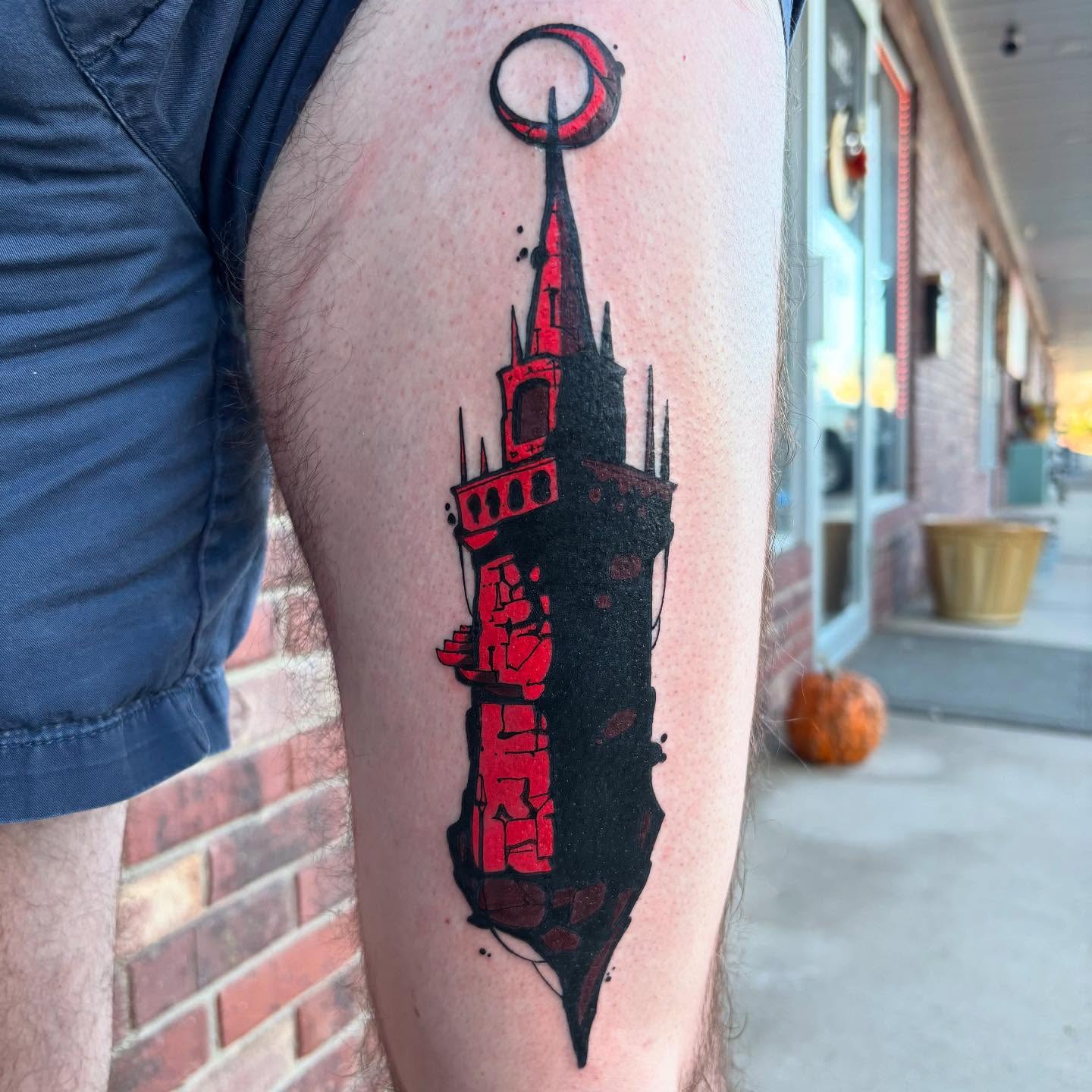 Tower black and grey tattoo on the thigh by Ghost Ham Tattoos