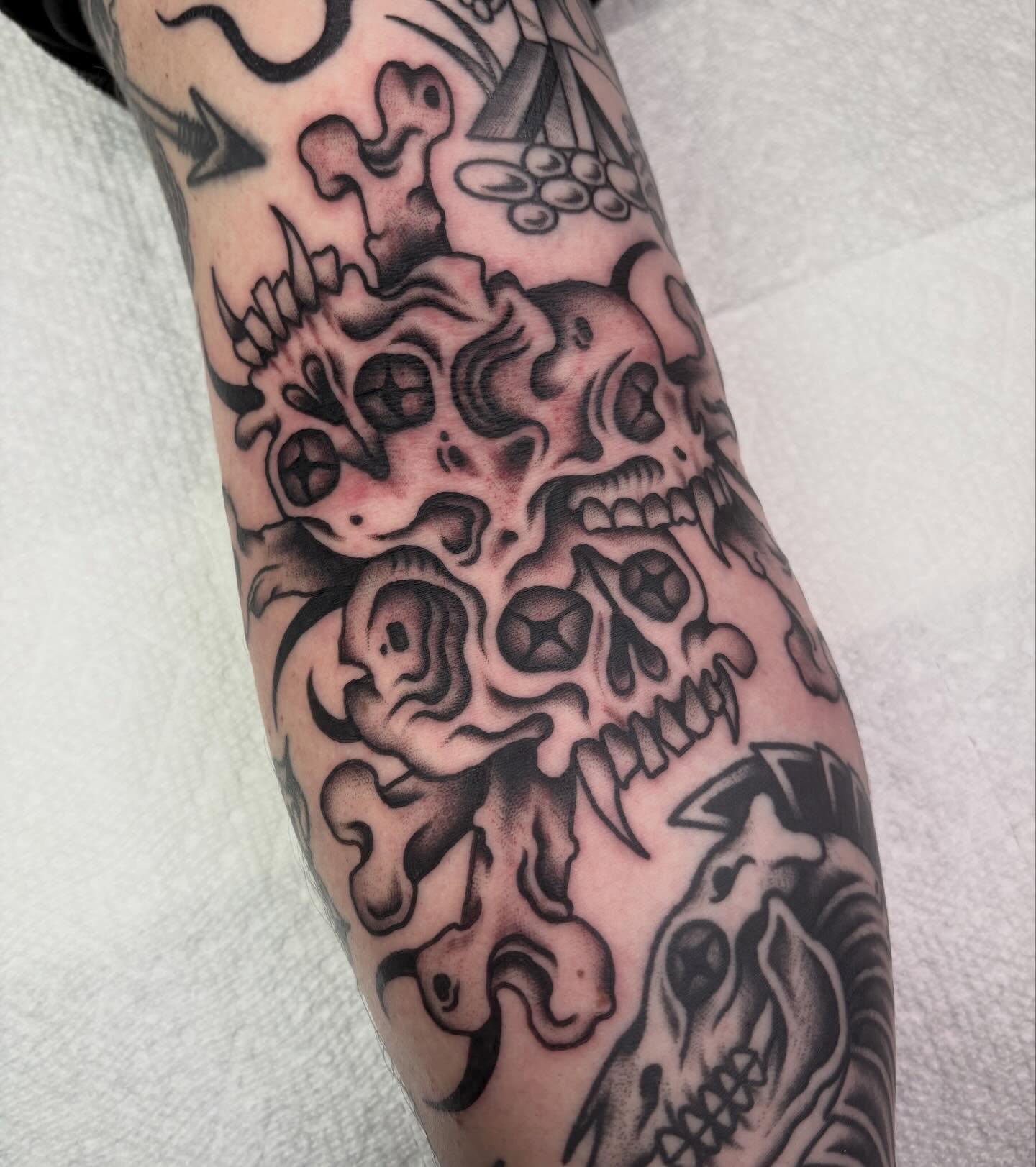 Skulls and flames surrealism tattoo on the forearm by sally ★ lee